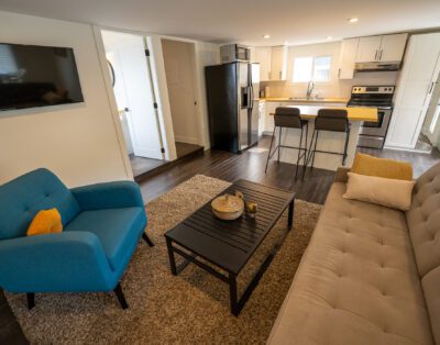 Cozy living room with curated book collection and soundproofed walls at Rockcliffe Getaway Oliver BC