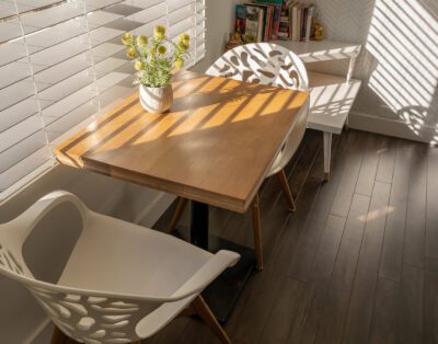 Dining area for two with curated book collection and soundproofed walls at Rockcliffe Getaway Oliver BC