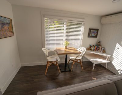 Dining area for two with curated book collection and soundproofed walls at Rockcliffe Getaway Oliver BC