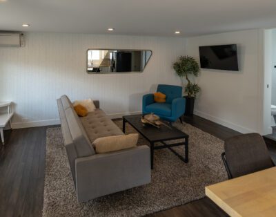 Cozy living room with curated book collection and soundproofed walls at Rockcliffe Getaway Oliver BC